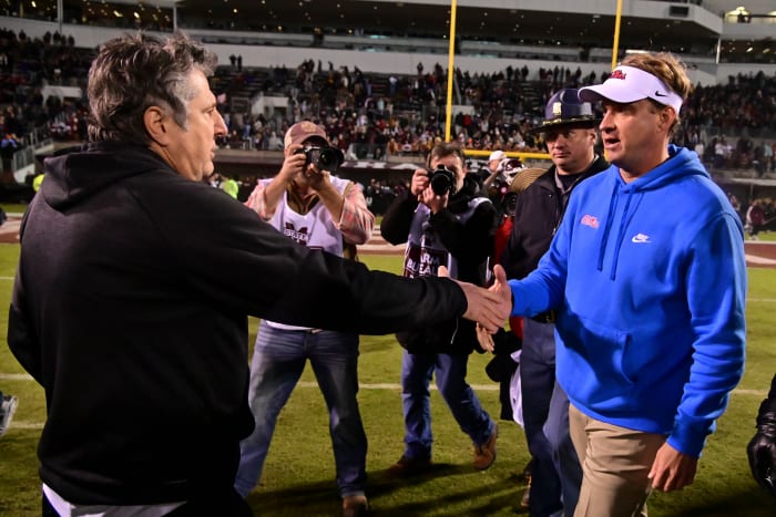 Nov 25, 2021; Starkville, Mississippi, USA; Mississippi State Bulldogs head coach Mike Leach and Mississippi Rebels head coach Lane Kiffin shake hands after the game at Davis Wade Stadium at Scott Field. Mandatory Credit: Matt Bush-USA TODAY Sports